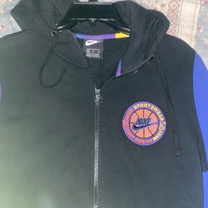 A zip up jacket purple,yellow,orange,blue, and black